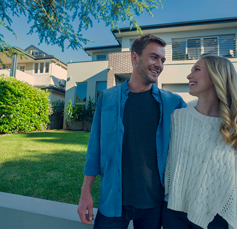 Couple in front of house